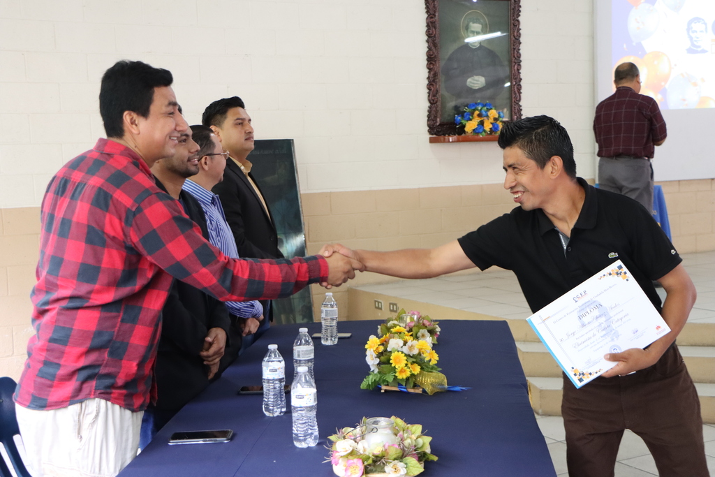 Uno de los 135 graduados del Centro de Formación Profesional Don Bosco recibe con orgullo su diploma técnico.